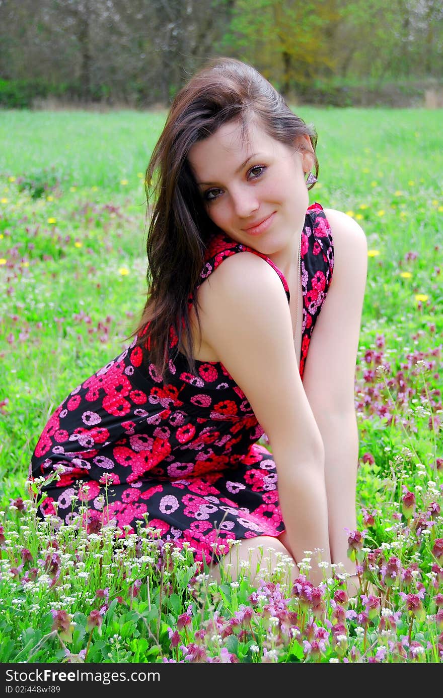 The beautiful girl walks on a solar meadow