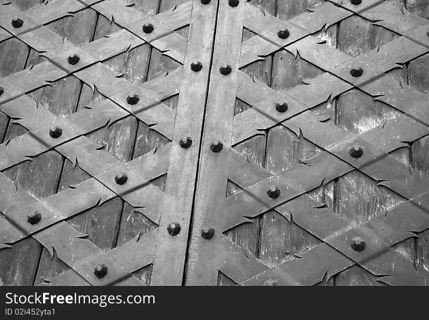 Old wooden door with metal ornament background in black and white. Old wooden door with metal ornament background in black and white