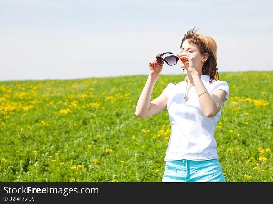 Beautiful young woman enjoying a sunny day of spring in the nature. Beautiful young woman enjoying a sunny day of spring in the nature