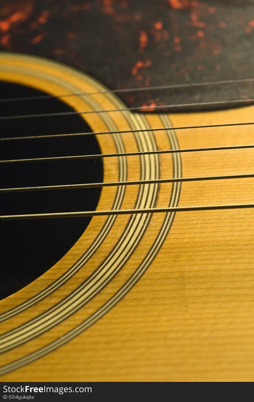 A wooden acoustic guitar with metal strings. A wooden acoustic guitar with metal strings.