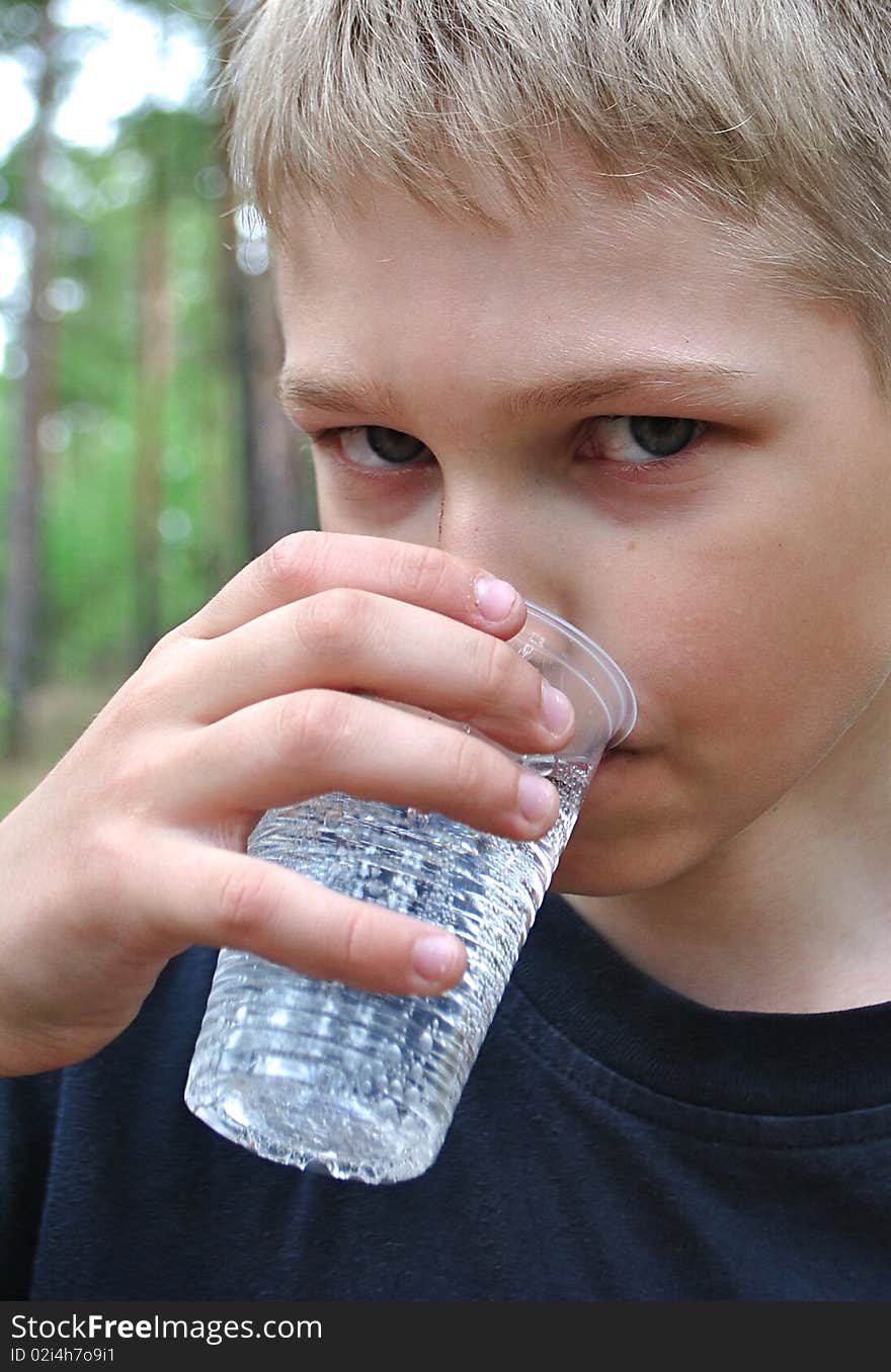 Water.Teenager drinks from can.