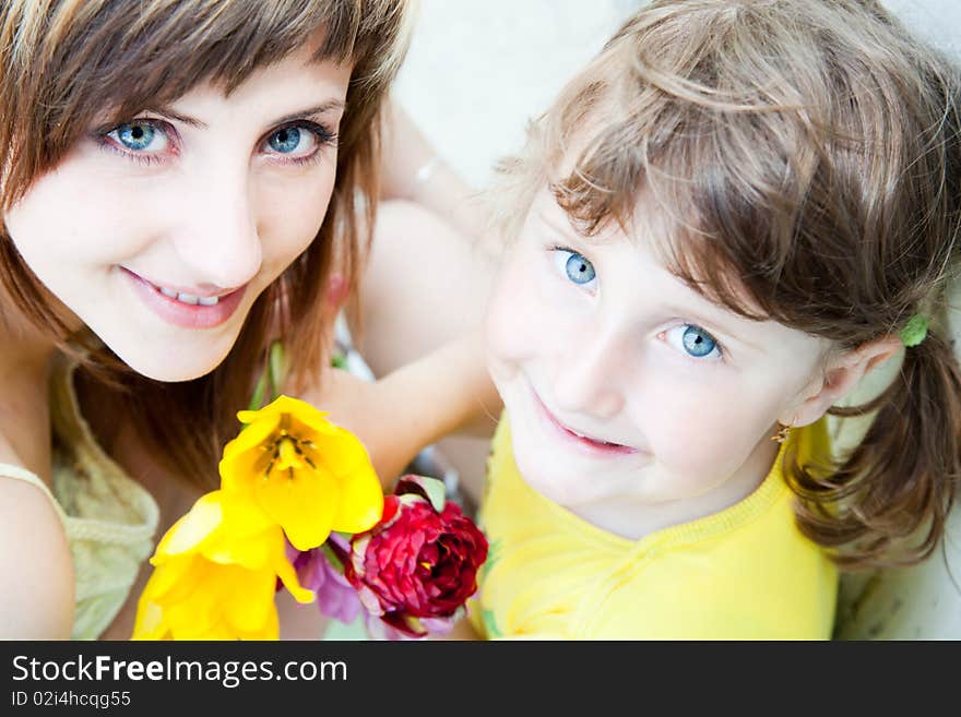 Young woman and little girl portrait enjoying a day outside. Young woman and little girl portrait enjoying a day outside.