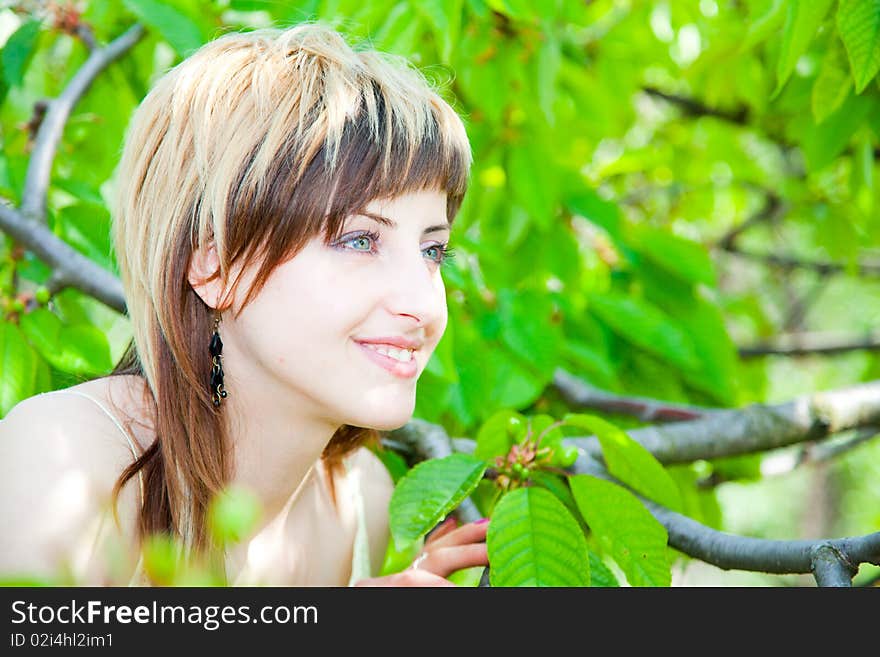 Beautiful young girl enjoying the sunny day in an orchard. Beautiful young girl enjoying the sunny day in an orchard