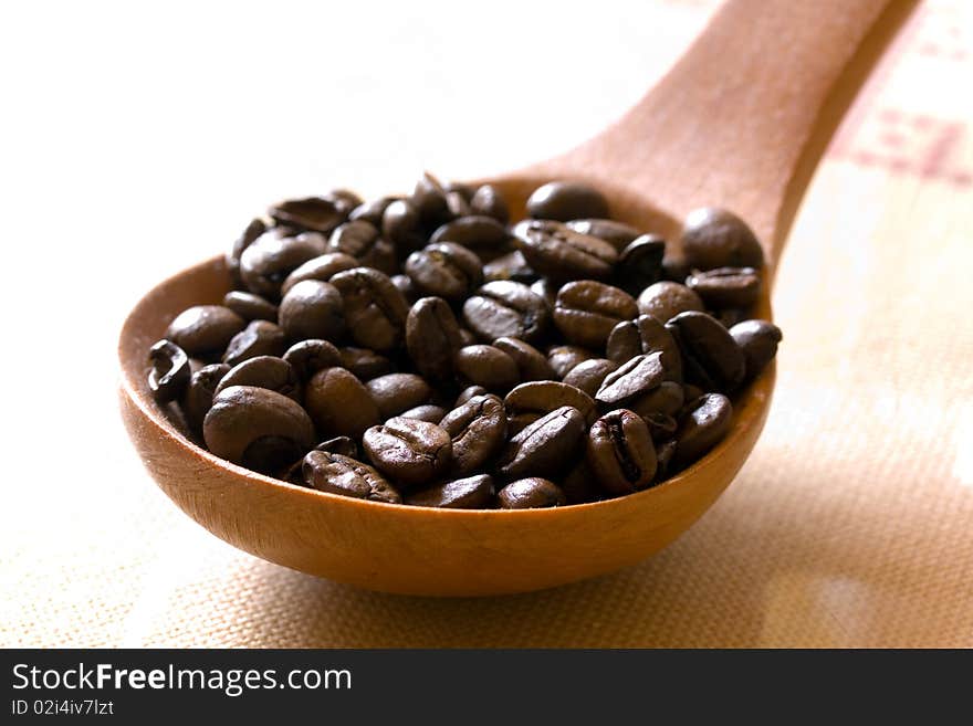 Fresh roasted,coffee beans in the spoon,close up