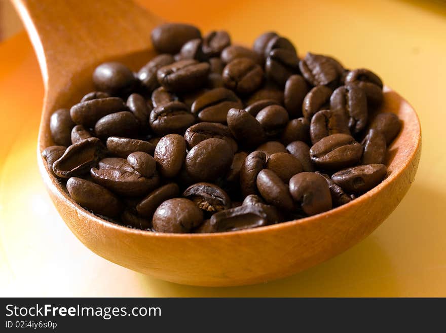 Fresh roasted,coffee beans in the spoon,close up