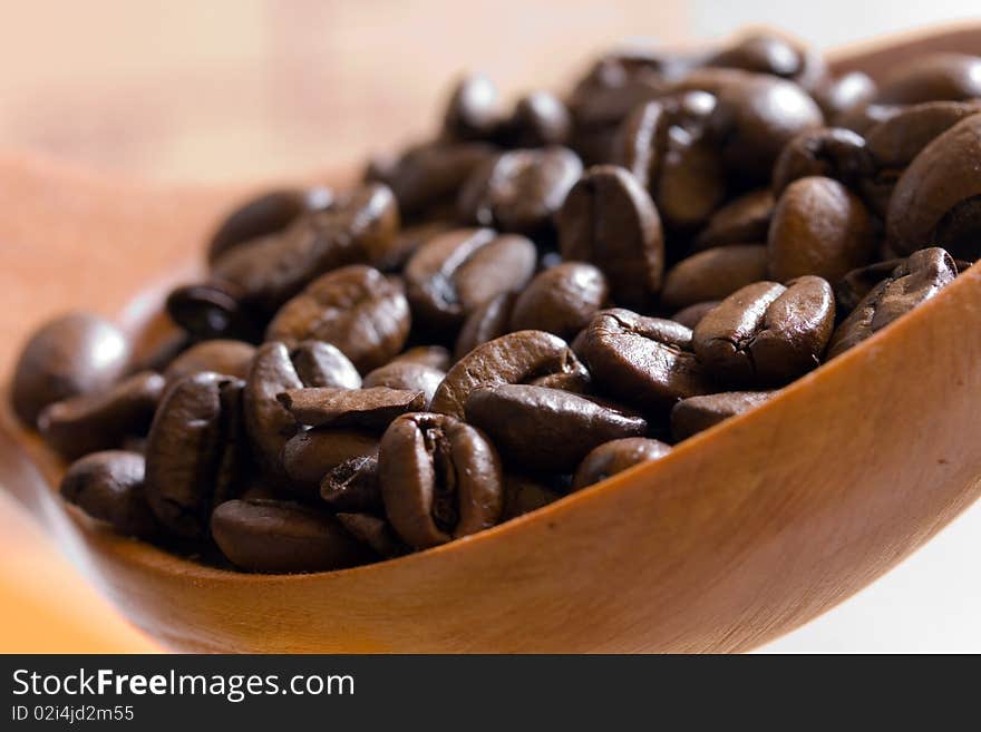 Fresh roasted,coffee beans in the spoon,close up