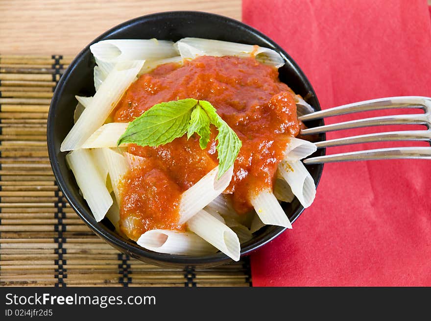 Closeup on a bowl with fresh rice penne. Closeup on a bowl with fresh rice penne