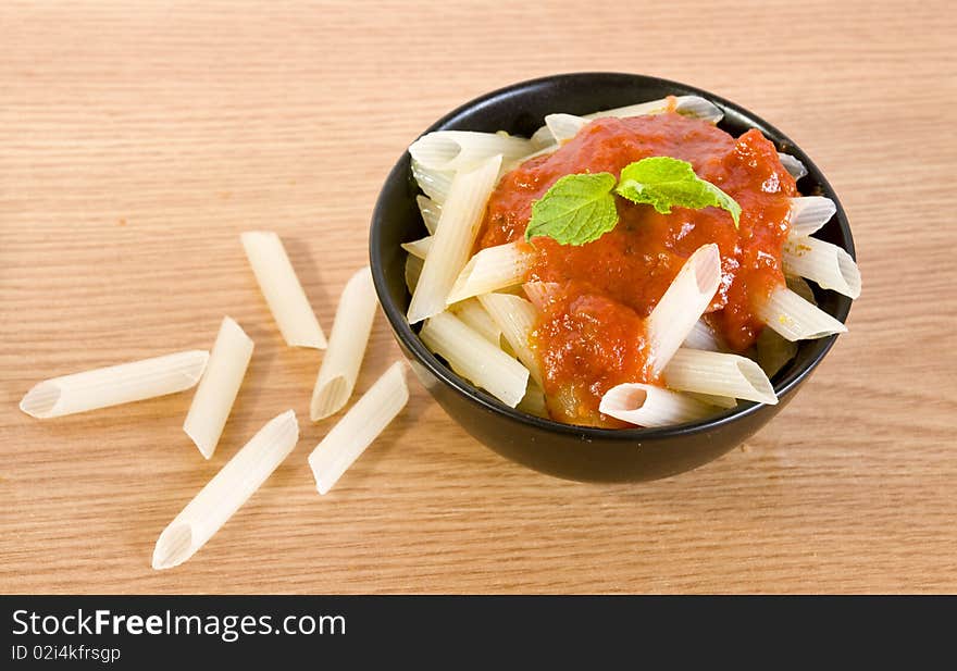 Freshly cooked rice penne with hot tomato sauce