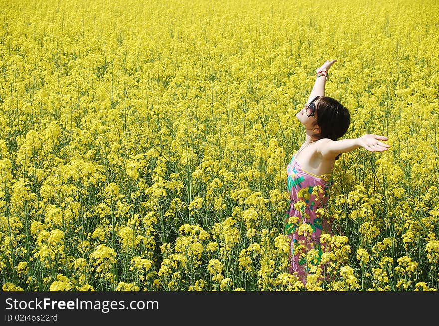 Young girl enjoying a sunny day on canola field. Young girl enjoying a sunny day on canola field