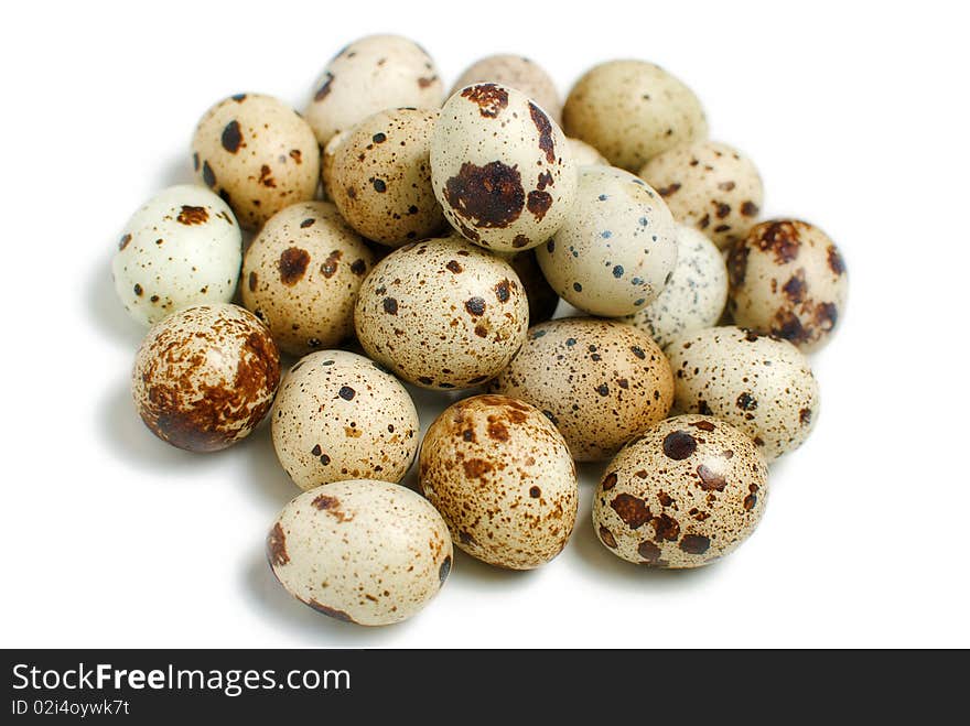 A pile of fresh quail eggs was shot is white background