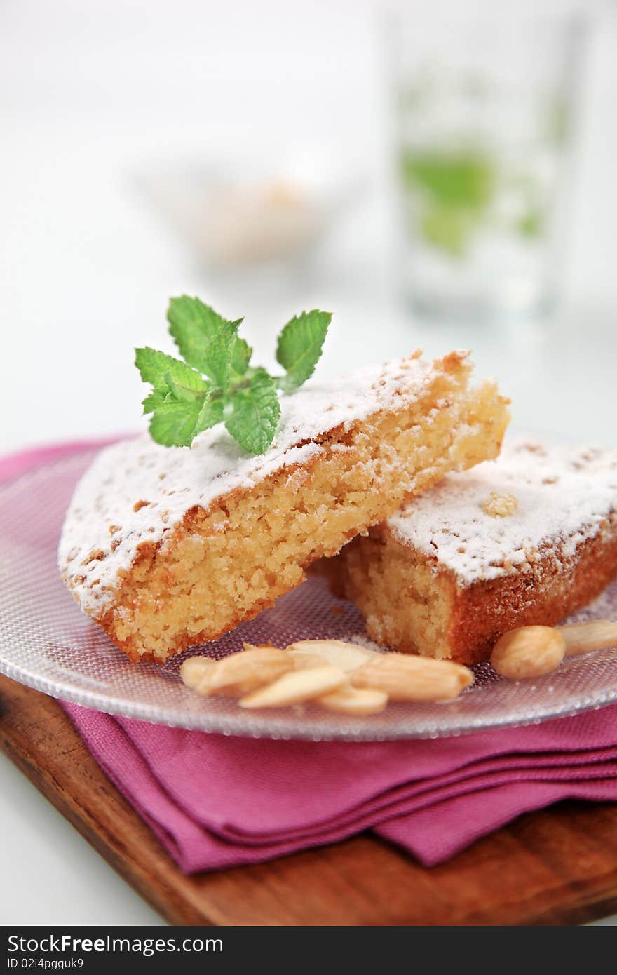 Slices of sponge cake sprinkled with icing sugar