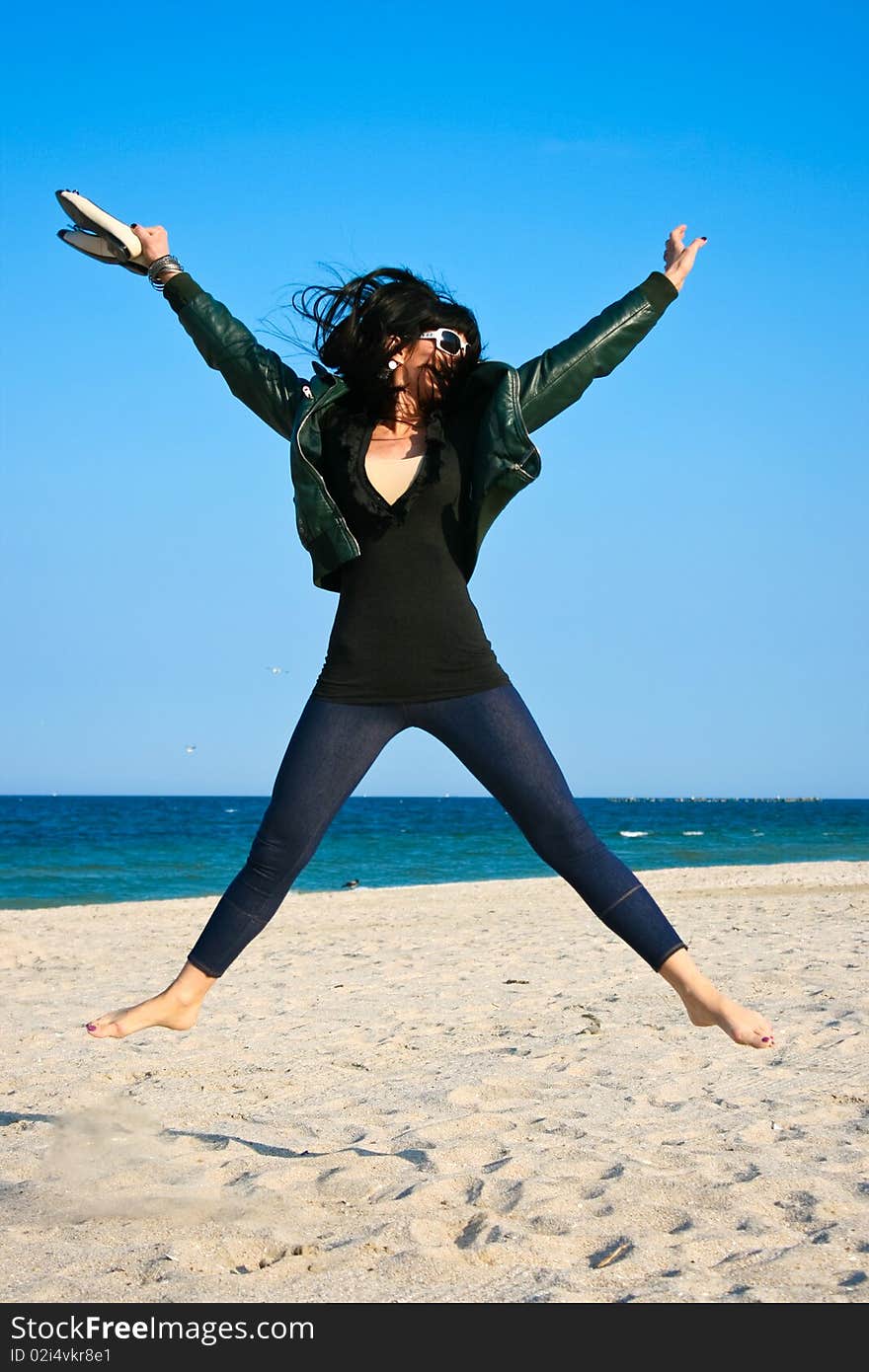 Woman jumping on the beach