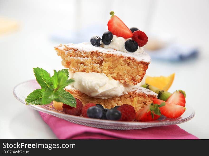 Slices of sponge cake with cream and fruit. Slices of sponge cake with cream and fruit