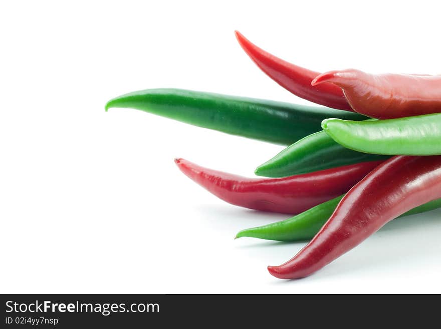 Green and red chili peppers on white background