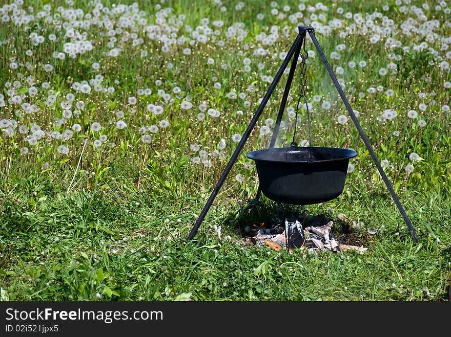 Tourist cauldron	boiling on a fire. Tourist cauldron	boiling on a fire