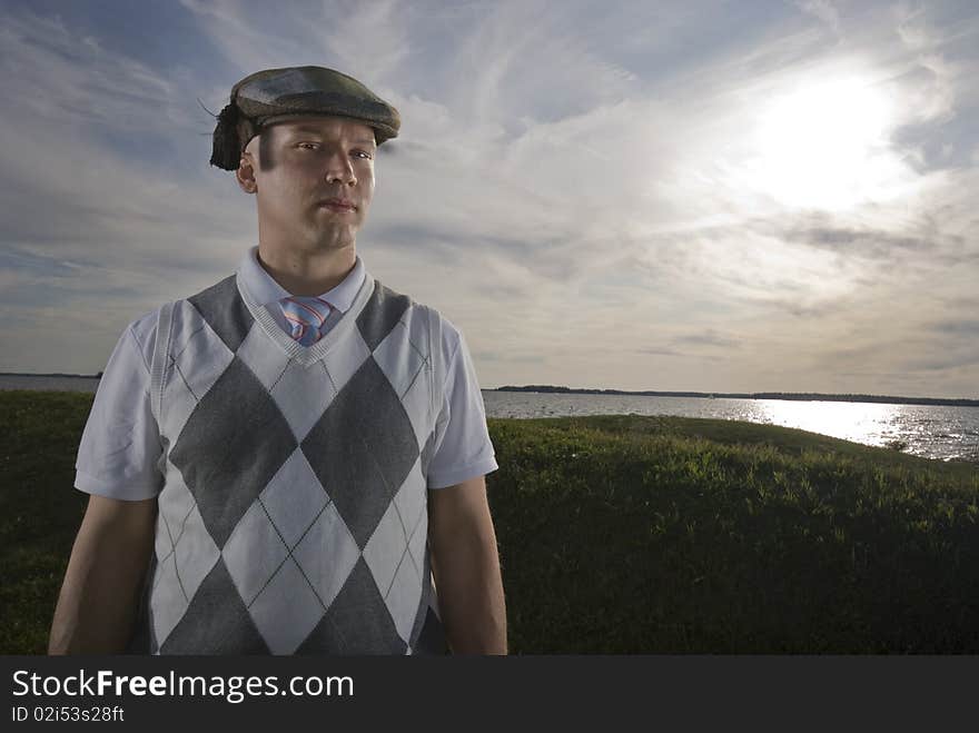 Outdoors portrait of an handsome man wearing a funny hat. Outdoors portrait of an handsome man wearing a funny hat.