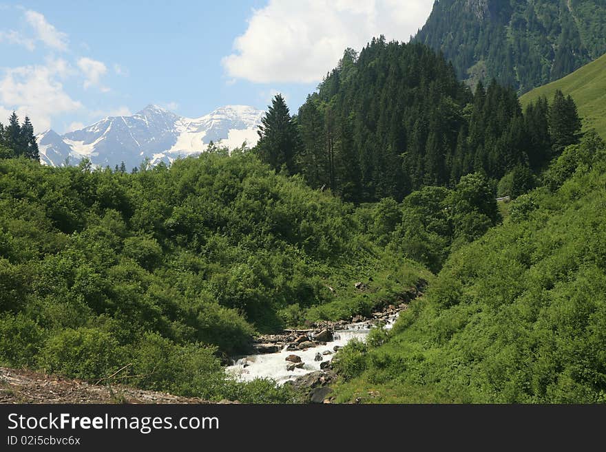 Austrian Alps view with stream and glacier. Austrian Alps view with stream and glacier