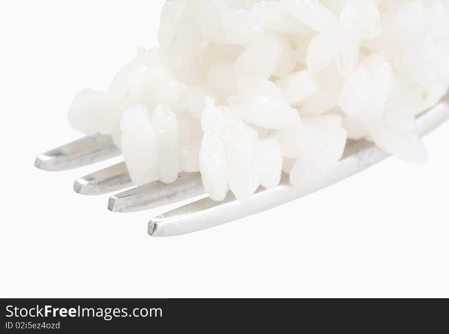 Fork with rice macro isolated on white studio shot