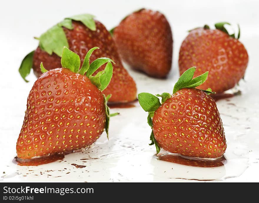 Fresh delicious  and sweet strawberries on wet background