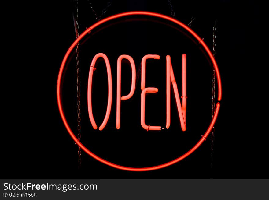 A red circle of neon lighting containing the word 'OPEN'. A red circle of neon lighting containing the word 'OPEN'.