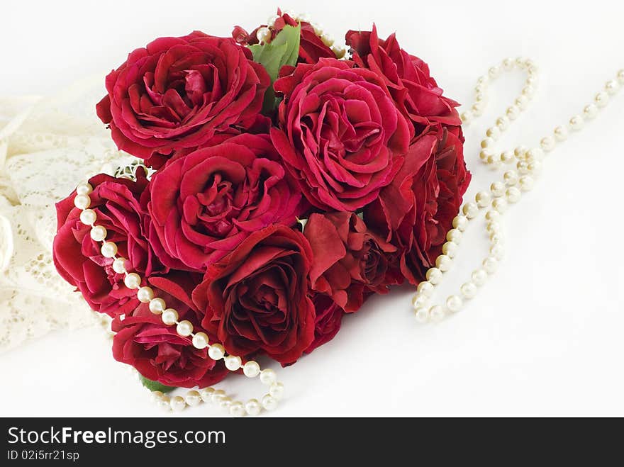 A red rose bouquet with lace and pearls on a horizontal background, perfect for Valentine's Day. A red rose bouquet with lace and pearls on a horizontal background, perfect for Valentine's Day