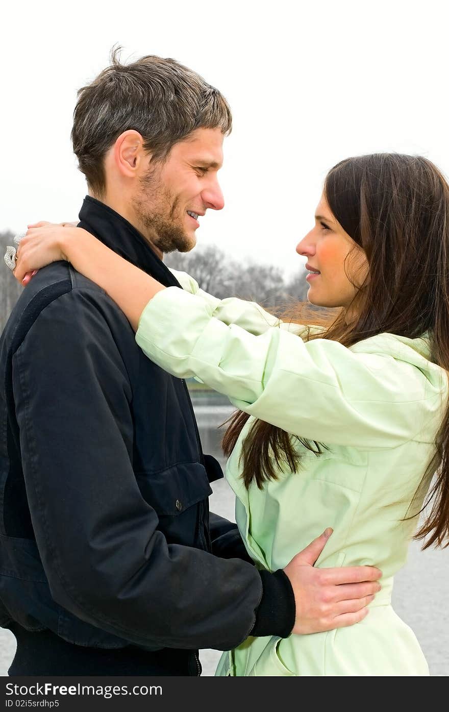 Young loving couple near the lake