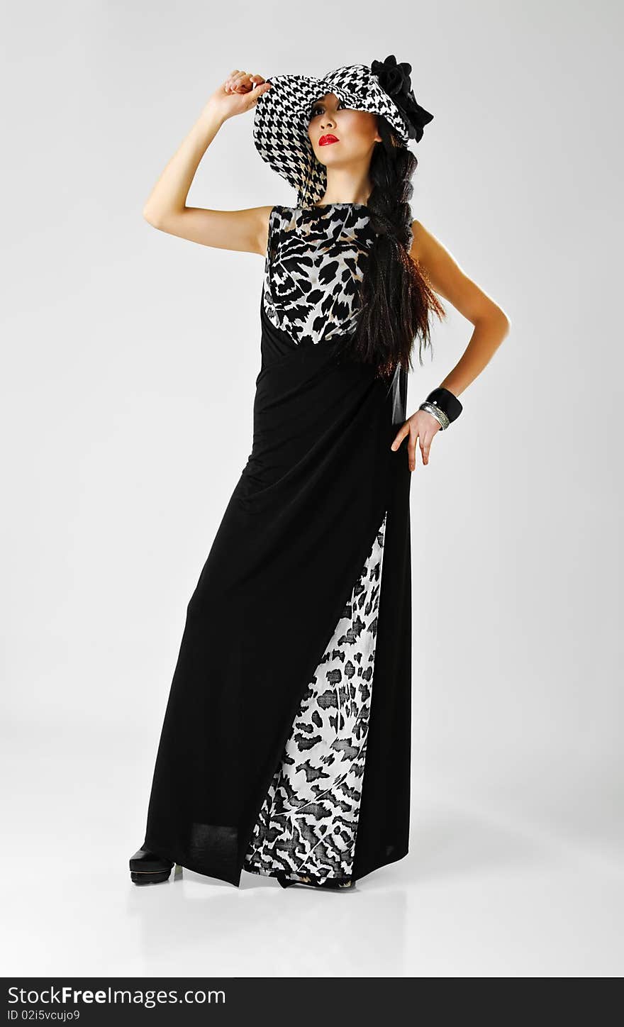 Beautiful asian model in evening dress on grey. Beautiful asian model in evening dress on grey