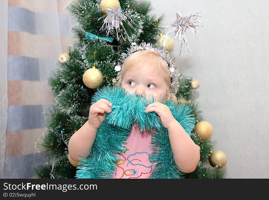 Pretty little girl and christmas-tree.