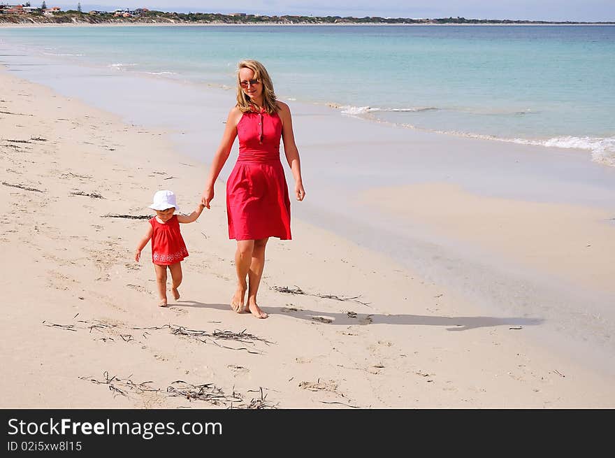 The little girl and mother near the ocean