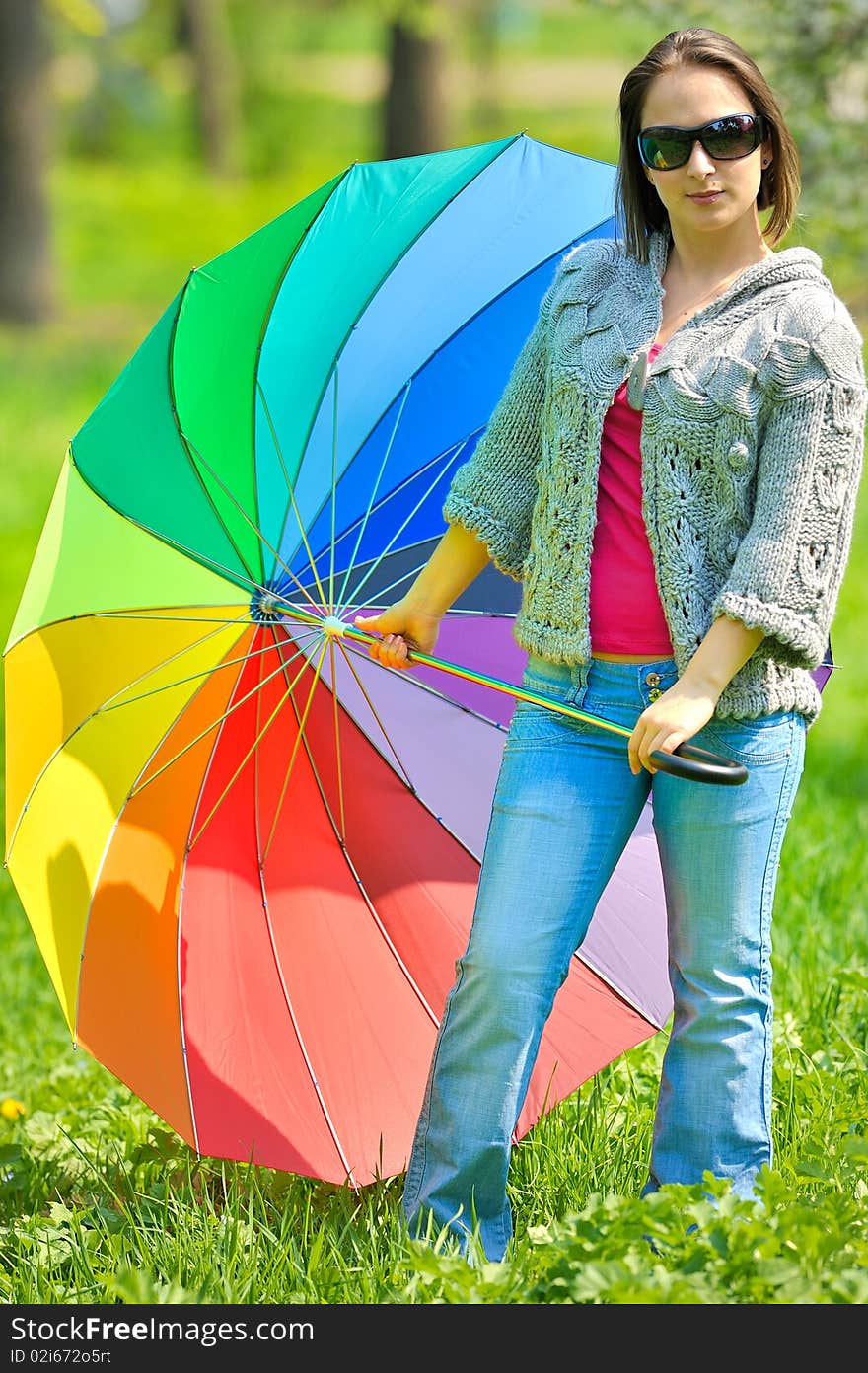 Beautiful woman with umbrella in rainbow colors