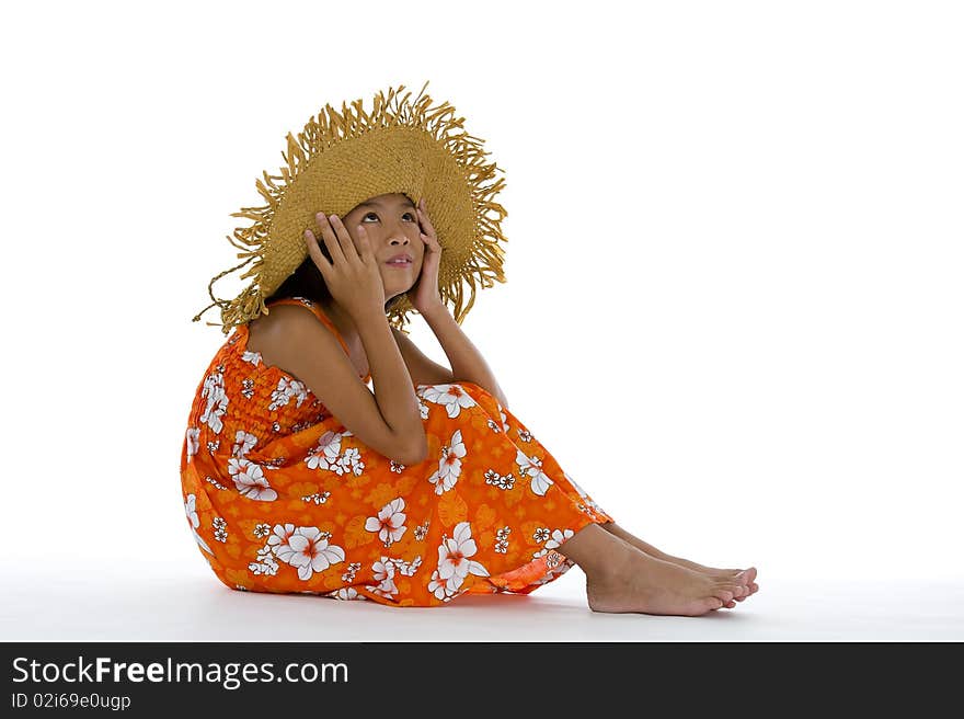 Cute girl sitting on the floor with straw hat and looking up to the ceiling, isolated on white background. Cute girl sitting on the floor with straw hat and looking up to the ceiling, isolated on white background