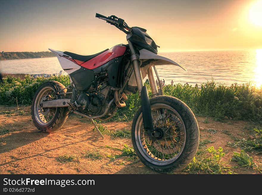 Motorcycle enduro and sunset on the beach