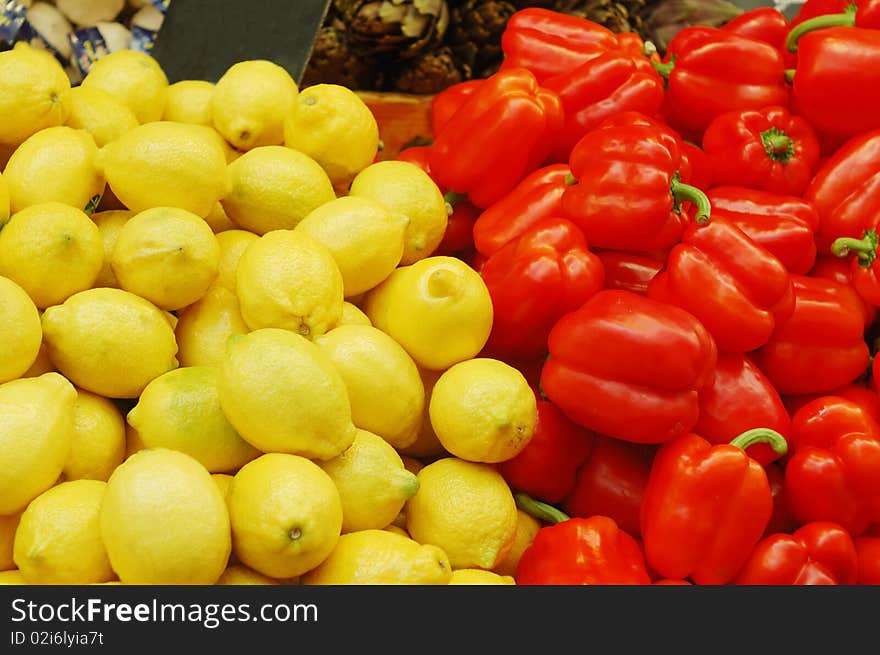 Close up of lemons and red peppers on market stand