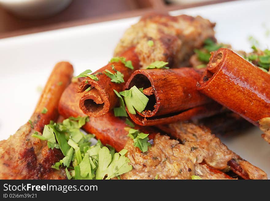 Kebab on cinnamon sticks with parsley