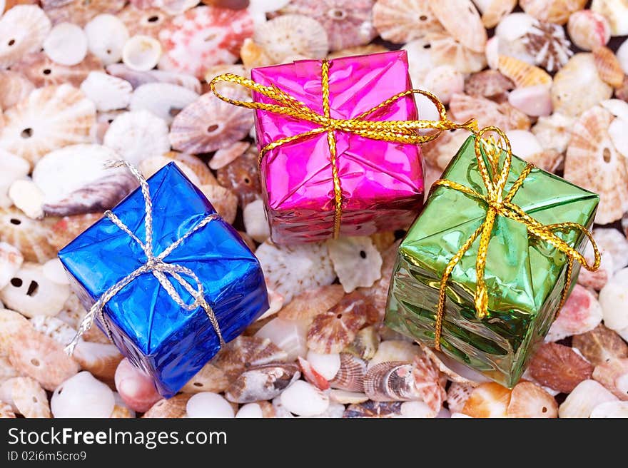 Present boxes on seashell background