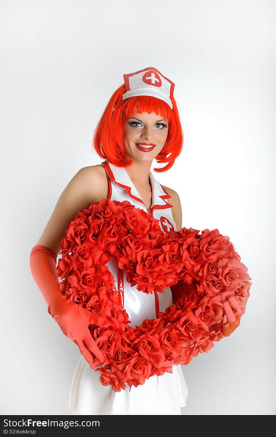 Young nurse with red hair and red heart. Young nurse with red hair and red heart