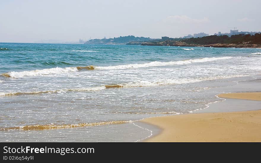 Surf on the bank of the Mediterranean sea in summer day. Coasta Dourada. Spain. Surf on the bank of the Mediterranean sea in summer day. Coasta Dourada. Spain.