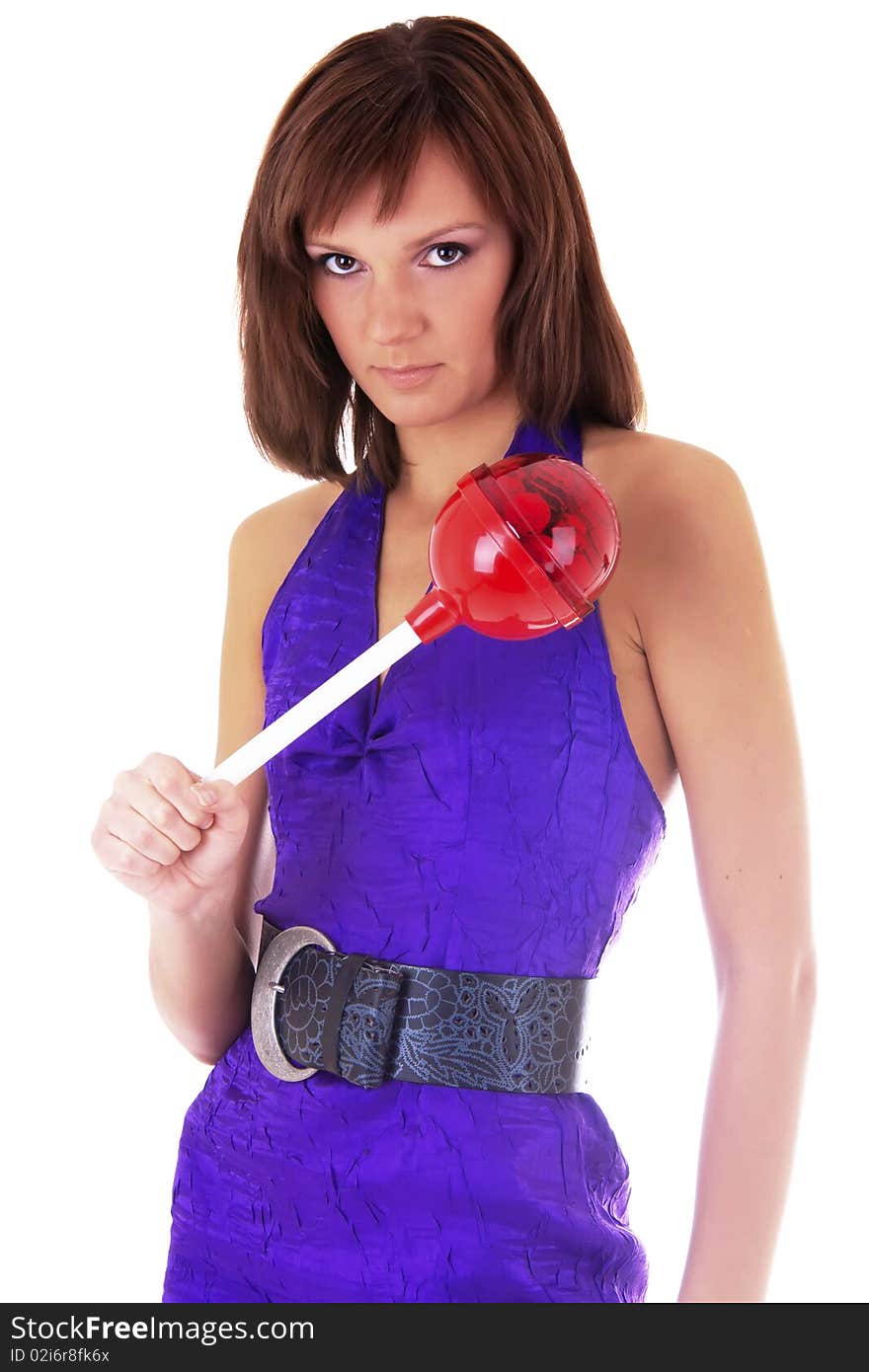 Portrait of a beautiful woman in violet dress with a lollipop in her hands. studio work