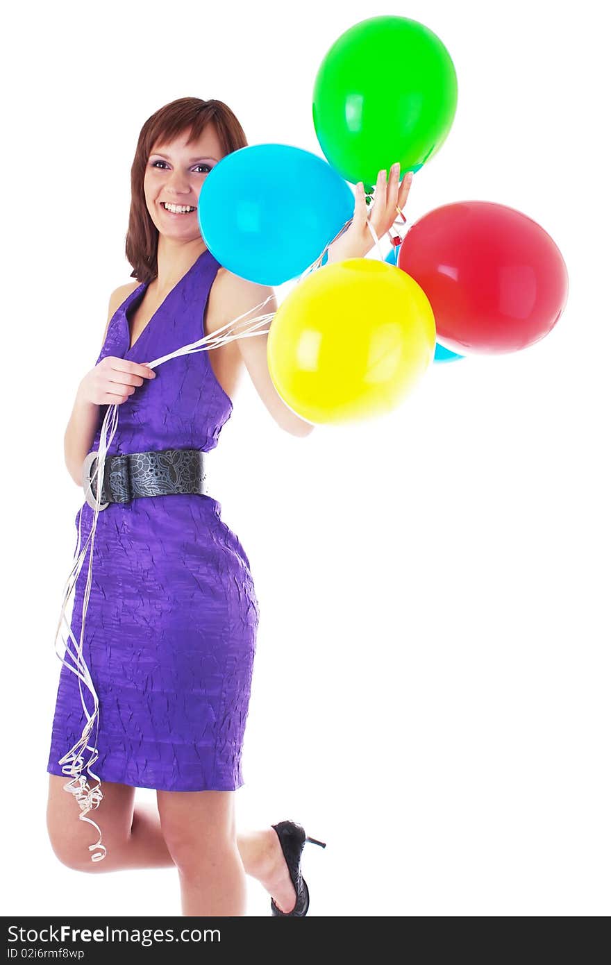 Beautiful woman posing in violet dress with a color balloons in her hands. studio work