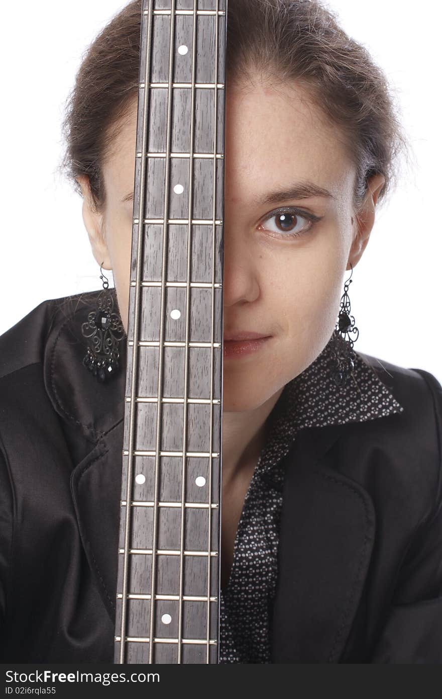 Young woman posing in studio with a black electric bass guitar. Isolated on white background. Young woman posing in studio with a black electric bass guitar. Isolated on white background