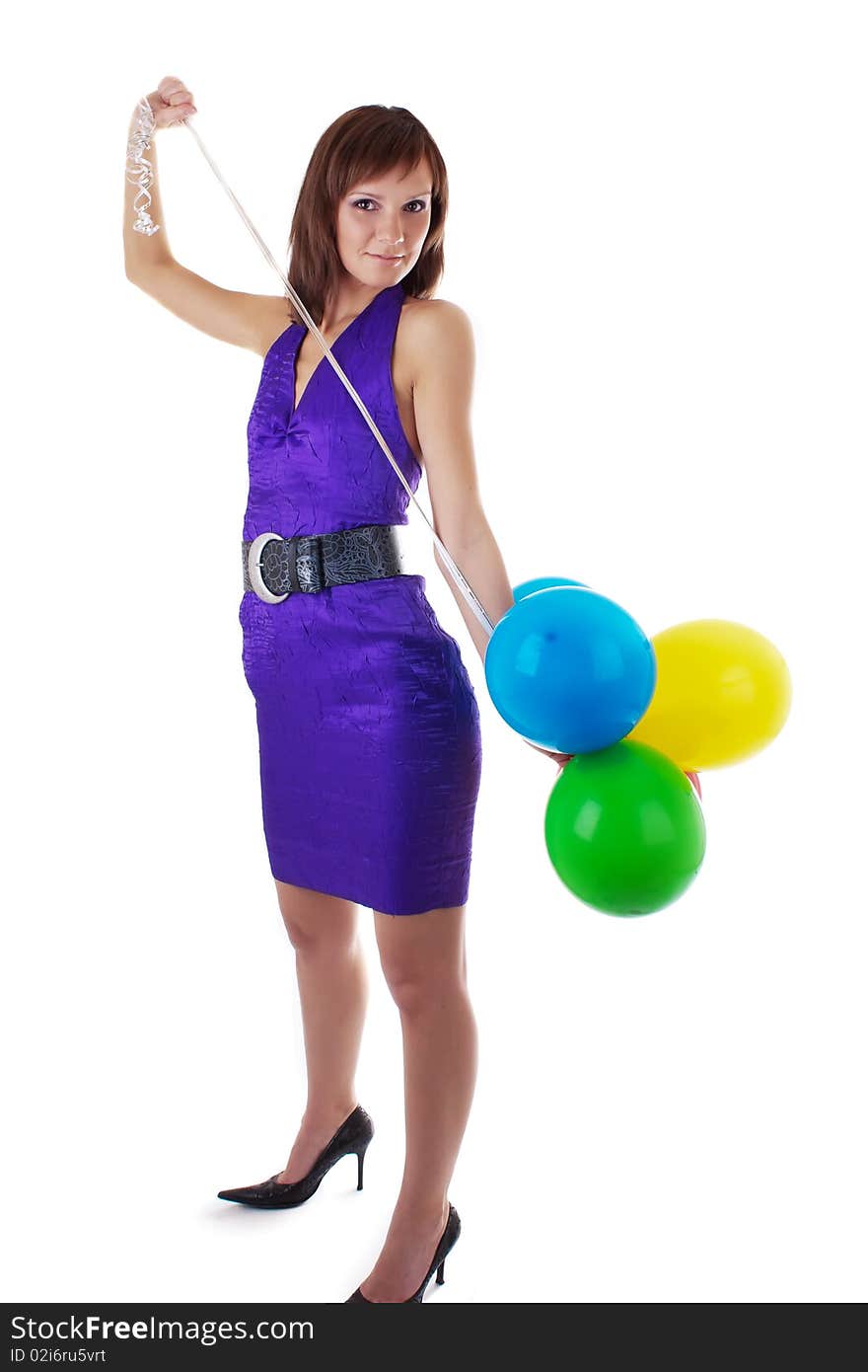 Smiling beautiful woman posing in violet dress with a color balloons in her hands. studio work