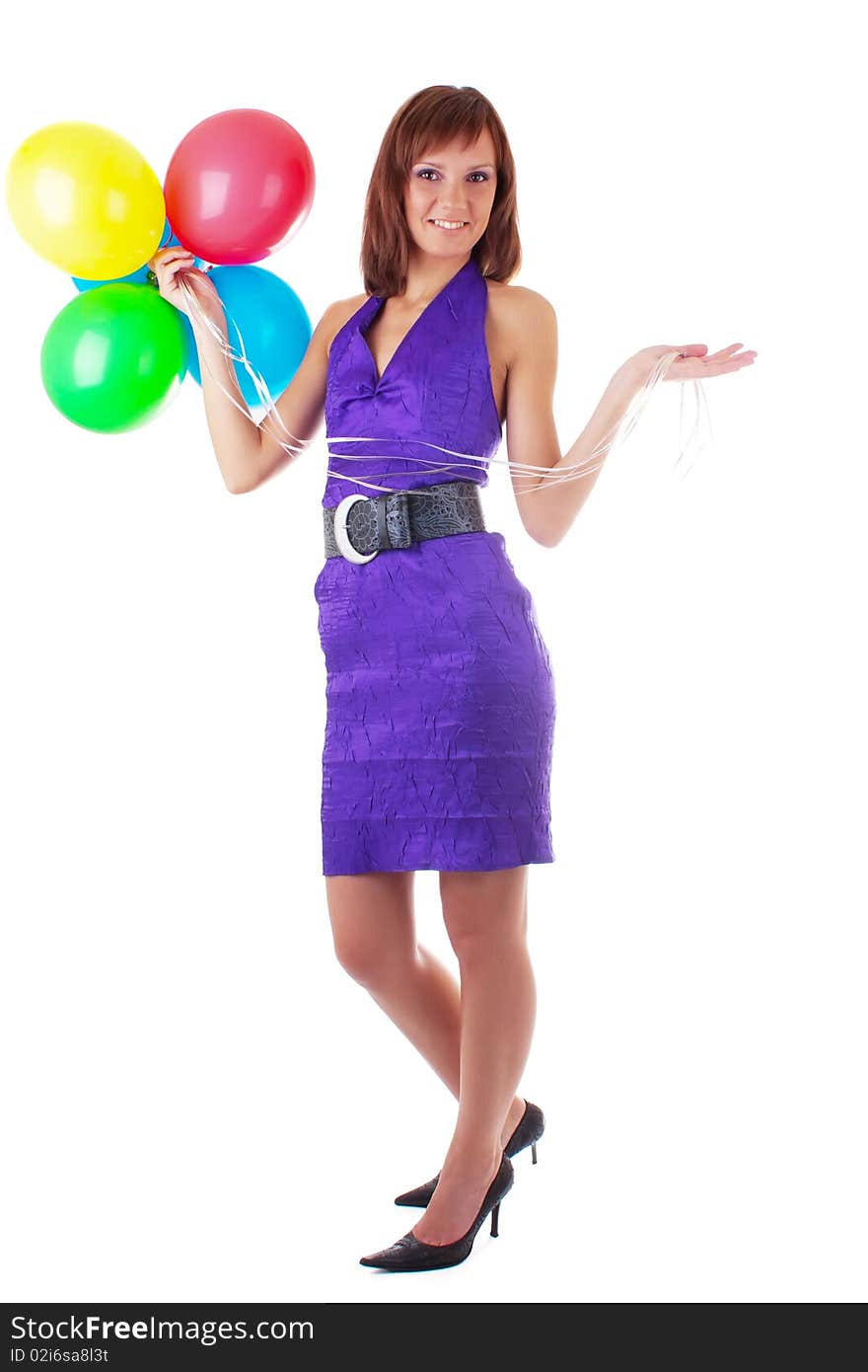 Smiling beautiful woman posing in violet dress with a color balloons in her hands. studio work