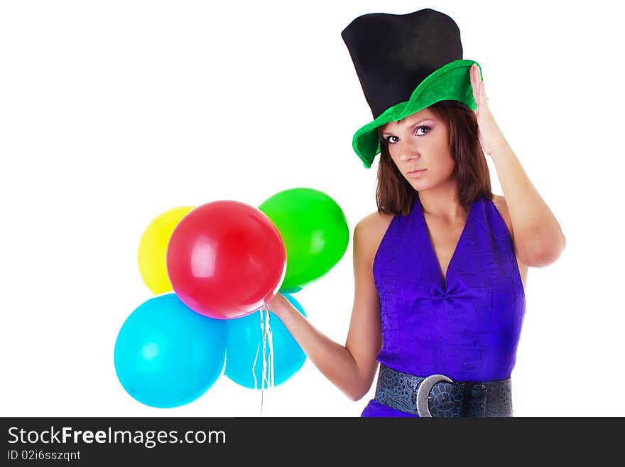 Portrait of a beautiful woman posing in hat and violet dress with a color balloons in her hands. studio work