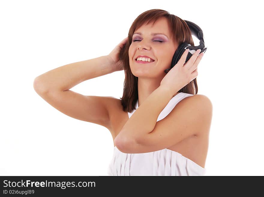 Close up Portrait of a beautiful woman listening music in headphones and white dress isolated on a white background