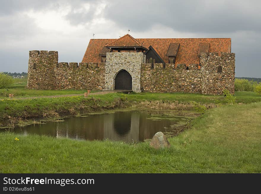 Small old style castle on pond. Small old style castle on pond