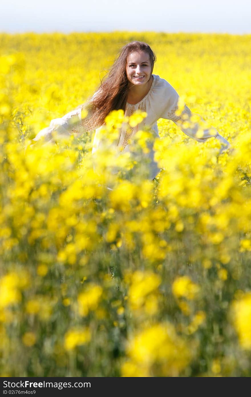 Happy girl in yellow flowers