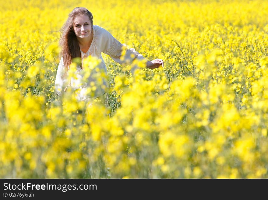 Happy girl in yellow flowers