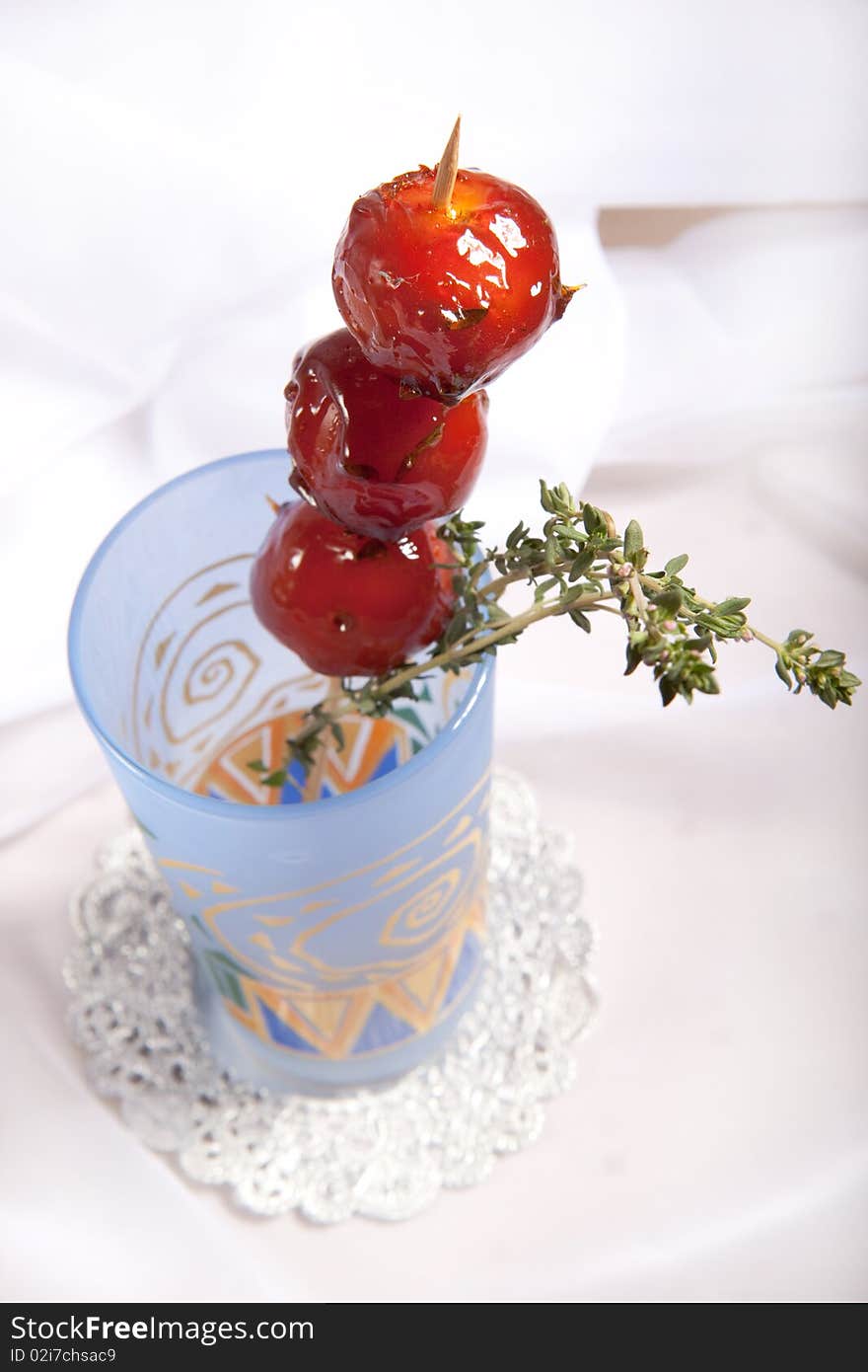 Sweet cherry tomato in colorful glass