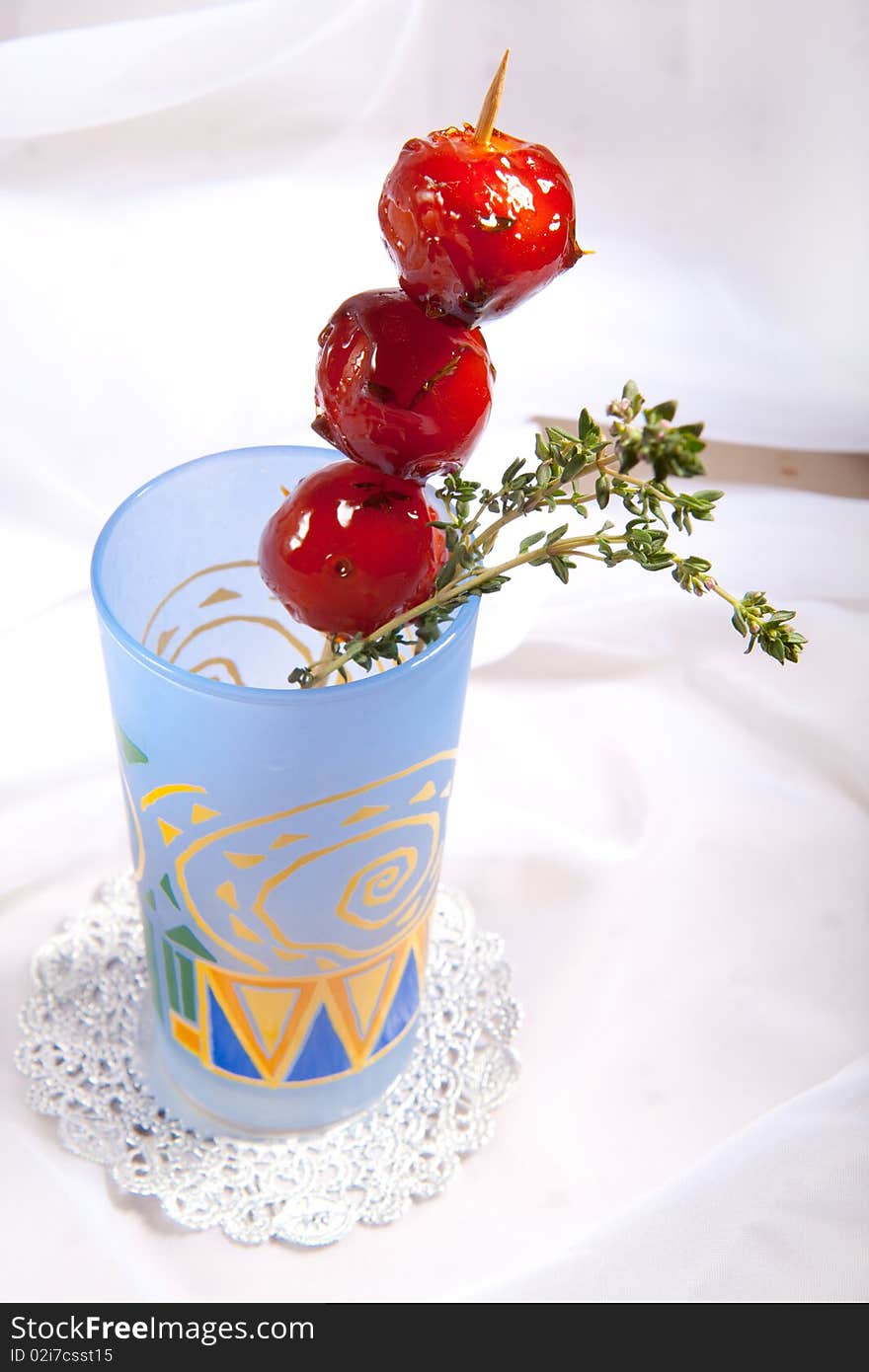 Sweet cherry tomato in colorful glass