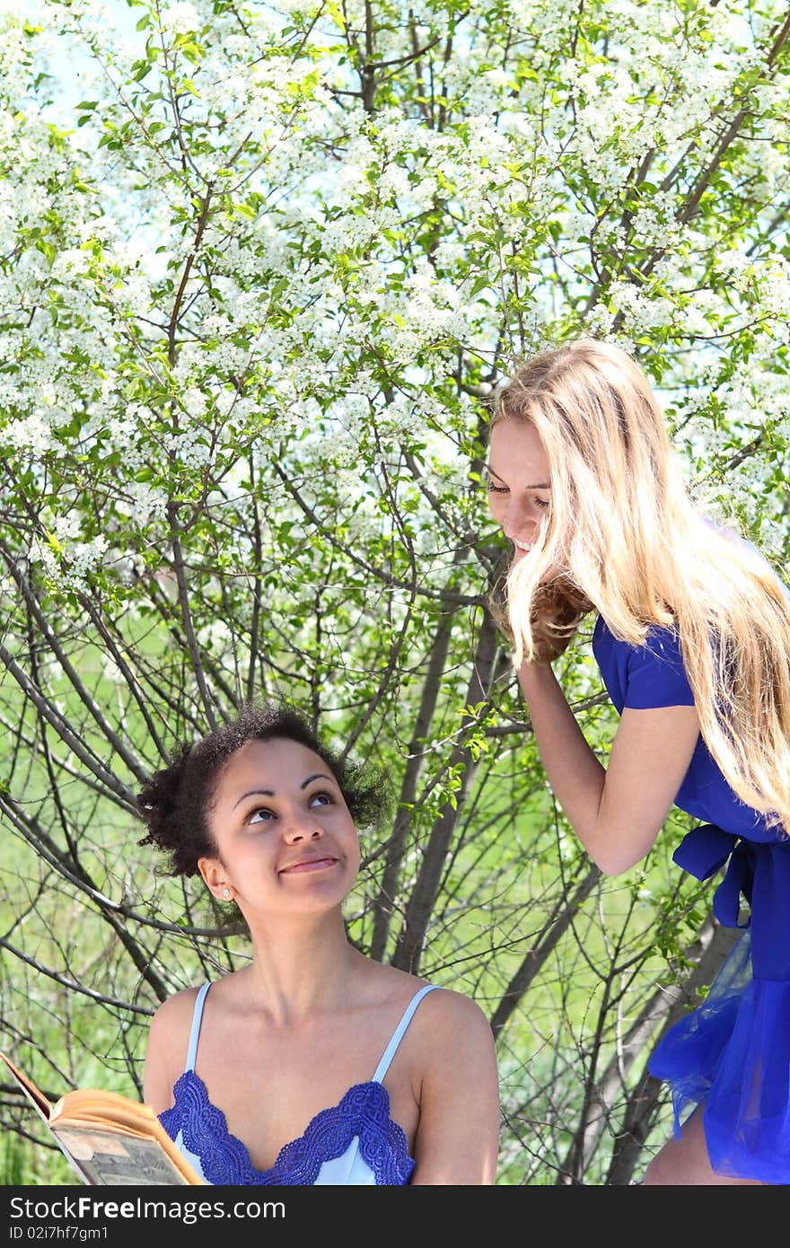 Two Girls In Blue In The Garden